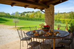 a table with bread on it on a patio at VILLA NASCA - Ville Carborello in Castelraimondo