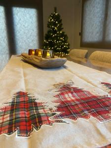 Una mesa de Navidad con un árbol de Navidad en el fondo en La Roanneuse - Cosy Chalet, en Francorchamps