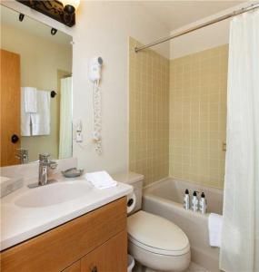 a bathroom with a sink and a toilet and a tub at RMR: Wind River 10 Condo in Teton Village in Teton Village +15 photos