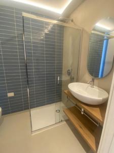 a bathroom with a sink and a glass shower at Mediterranea in Arenzano