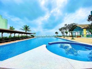 a swimming pool at a resort with blue water at Căn Hộ Vũng Tàu in Xa Thang Nhut