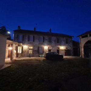 a house with a car parked in front of it at night at Ancient farmhouse 