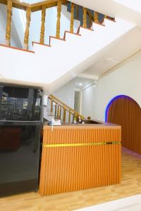 a kitchen with a wooden counter and stairs at Trung Hiếu Hotel - bên cạnh Miếu Bà Chúa Xứ in Chau Doc
