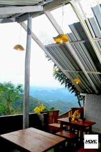 a patio with tables and a view of the mountains at moye moye Ella in Ella
