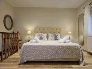 a bedroom with a large bed with white sheets and pillows at Villa Bacchus Kassiopi Corfu in Kassiopi +52 photos