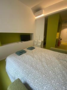 a bedroom with a bed with two towels on it at Mediterranea in Arenzano