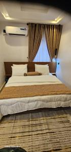 a bedroom with a large bed with a window at Ladi's Place 2, Anthony, Ikeja in Lagos