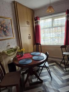 a room with a table and chairs and a window at Amarillys Guest House in Preston