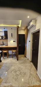 a living room with a kitchen and a dining room at Ladi's Place 2, Anthony, Ikeja in Lagos +1 photo