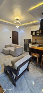 a large living room with a couch and a kitchen at Ladi's Place 2, Anthony, Ikeja in Lagos