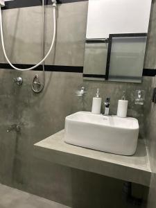 a bathroom with a white sink and a shower at Tropictide Weligama in Nikawatawana +22 photos