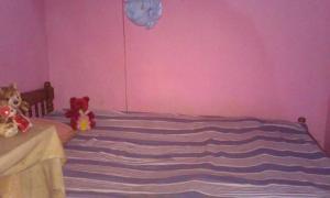 a bedroom with a bed with two stuffed animals on it at Vilage Home in Polonnaruwa