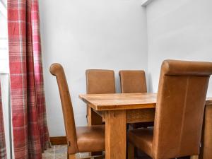a wooden table with two chairs and a wooden table and a table and chairsuggest at Juniper Cottage in Hook Norton