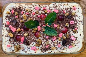 a cake with chocolate and cherries on a table at La Maison narbonnaise in Narbonne