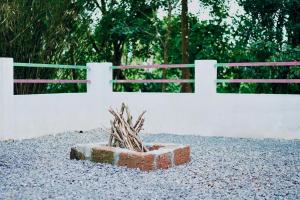 a brick box sitting in front of a white fence at Nyx Villa in Mananthavady