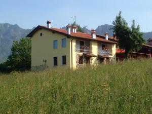a house on top of a hill in a field at La Casa nella Vecchia Ferrovia in Arsiero