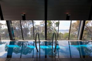 a swimming pool with windows in a building at The Pavilions at Mona in Hobart