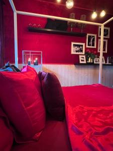 a red couch in a room with a red wall at romantic house in Poelkapelle