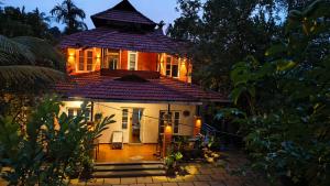 a small house with a purple roof at Nostalgia Homestay in Vythiri