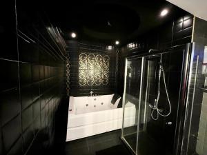 a black bathroom with a tub and a shower at Central Luxurious Ritz Villa in Sharm El Sheikh +38 photos