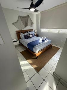 a bedroom with a bed and a ceiling fan at Pearl of the East in Ceiba with Ocean View and Private Rooftop in Santa Maria