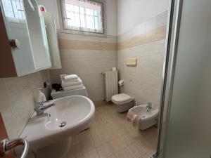 a bathroom with a sink and a toilet at Apartments Orio in Orio al Serio
