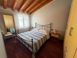 a bedroom with a bed in a room with a window at Apartments Orio in Orio al Serio