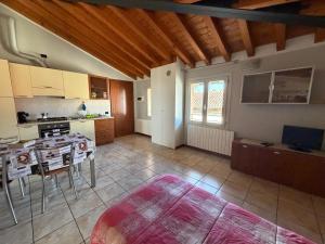 a large kitchen with a table and a counter top at Apartments Orio in Orio al Serio