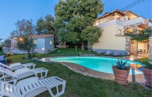 basen z krzesłami i domkiem w obiekcie Two-Bedroom Apartment In Veli Jezenj w mieście Veli Ježenj