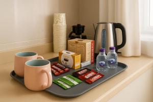 a tray with coffee and drinks on a counter at شقة هادئة بتصميم انيق ثلاث غرف ودخول ذاتي in Al Khobar +12 photos