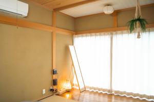a living room with a large window and a floor at ヴィラこんぴら Villa Konpira in Kotohira +18 photos