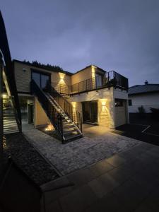 a house with a staircase in front of it at Luxuscontainer am Nürburgring #1 in Adenau