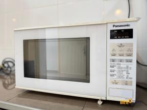 タイピンにあるTaiping Crystal Creek Condo Pool Gym Netflix 8-9PAXのカウンターの上に置かれた白い電子レンジ