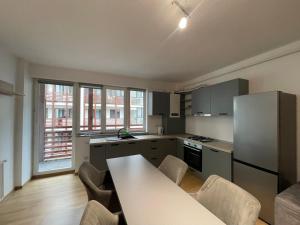 a kitchen with a table and chairs in a room at Cozy London Escape in Suceava