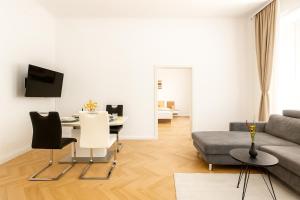 a living room with a couch and a table at Stilvolles Altbau Apartment - 2 Min zur U-Bahn, Nähe Donaukanal in Vienna