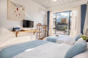 una camera d'albergo con due letti e una finestra di Dali Linghaoyun Homestay a Dali
