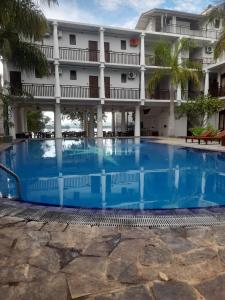 a large swimming pool in front of a building at Oga Reach Yala in Lukasgoda