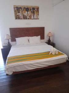 a bedroom with a large bed with a stuffed animal on it at Oga Reach Yala in Lukasgoda