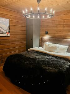 a bedroom with a bed and a chandelier at Mountain Lodge With Views Over Idre in Idre
