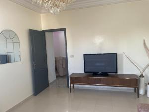 a living room with a flat screen tv on a table at Villa doullia in El Mây