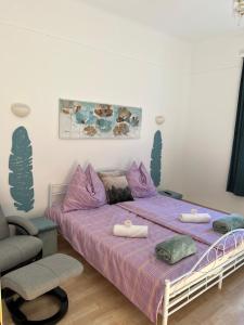 a bedroom with a bed with purple sheets and a chair at Ferienwohnung Hakuna Matata in Bad Aussee