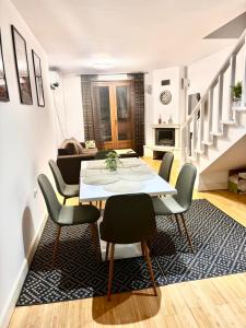 a dining room with a table and chairs in a living room at Pamporovo Duplex Apartment Fireplace 2 Bathrooms Shuttle in Smolyan