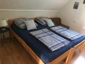 a bed with two pillows on top of it at PäRLAN APARTMAN in Balatonboglár