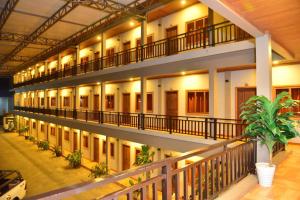 an apartment building with a balcony and a plant at Champadiamon hotel in Pakse