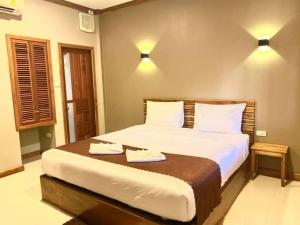 a bedroom with a bed with two towels on it at Champadiamon hotel in Pakse