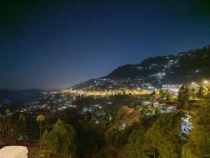 a view of a city at night at Montana Lodges Murree in Murree