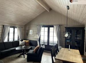 a living room with a couch and a table at Cozy family cabin at Hovden in Bykle