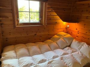 a large white bed in a room with a window at Cozy family cabin at Hovden in Bykle +17 photos