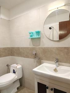 a bathroom with a toilet and a sink and a mirror at Montana Lodges Murree in Murree +76 photos