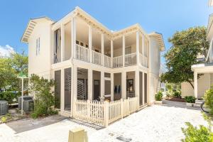 a large white house with a balcony at On the Beach in Santa Rosa Beach